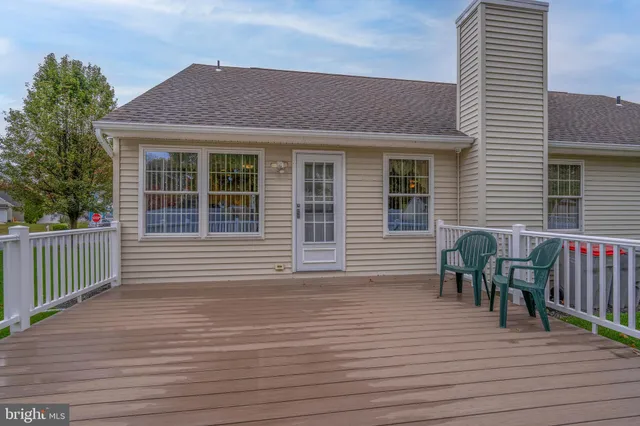 a view of a deck with wooden floor and fence
