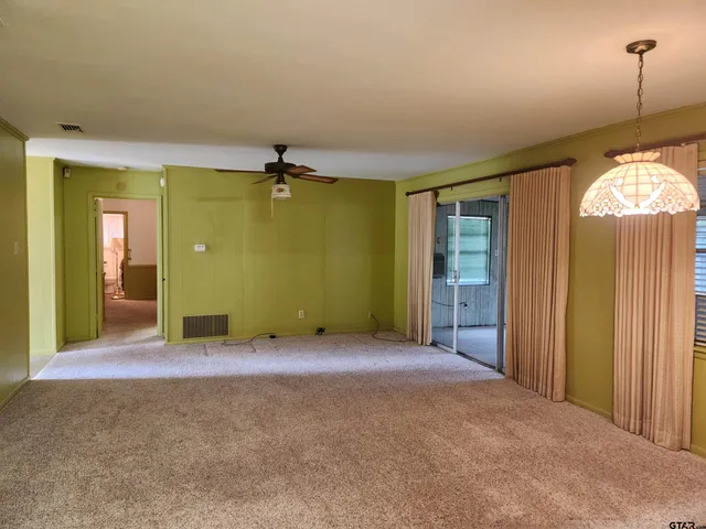 an empty room with windows and entrance