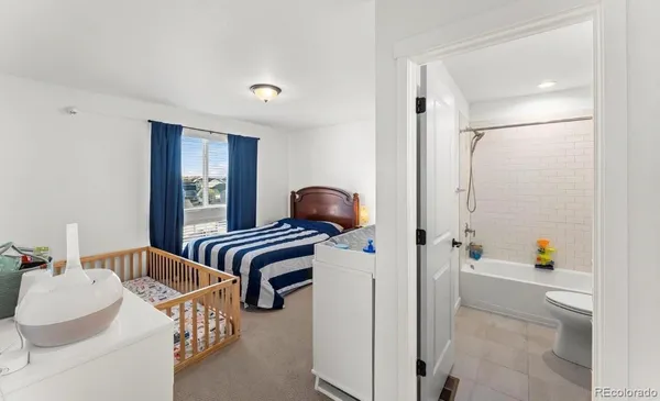 a bedroom with furniture and a window