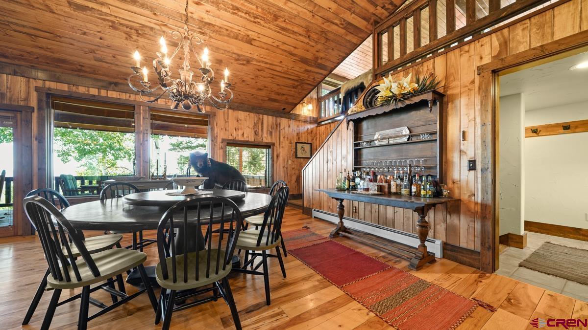 220 Ridge Road Cimarron, CO 81220 - Photo 16 of 45 a view of a dining room with furniture a chandelier and wooden floor