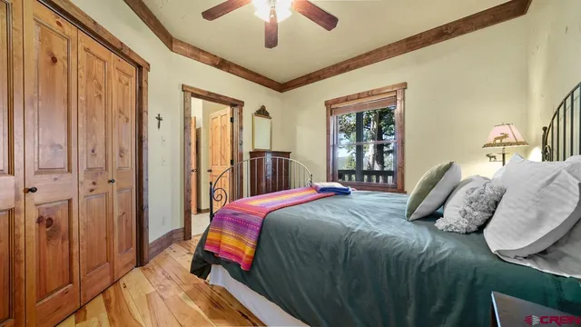 a bedroom with a bed and a chandelier