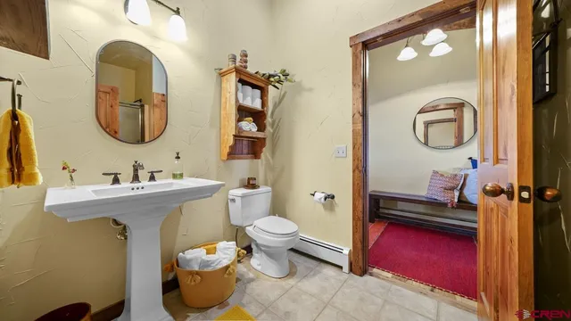 a bathroom with a toilet sink and mirror