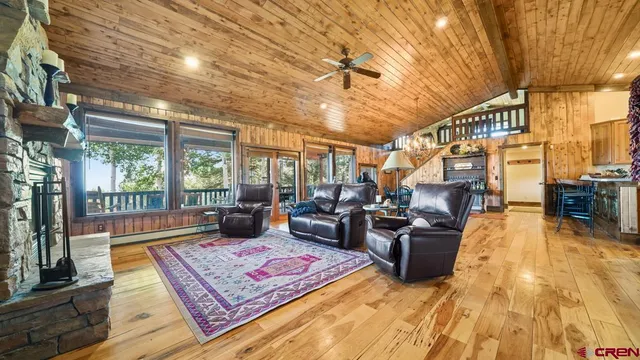 a living room with furniture rug and wooden floor