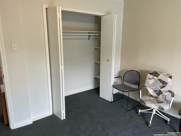 a bedroom with a bed couch and window