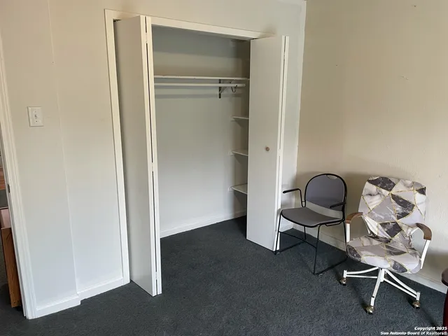 a bedroom with a bed couch and window