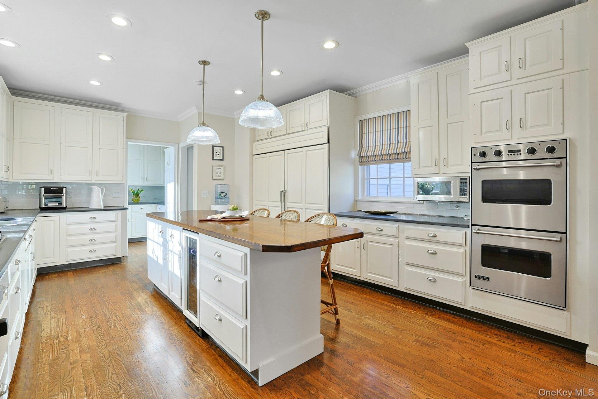 34 Park Road Scarsdale, NY 10583 - Photo 13 of 49 a large kitchen with a large stove a sink dishwasher and a stove with wooden floor