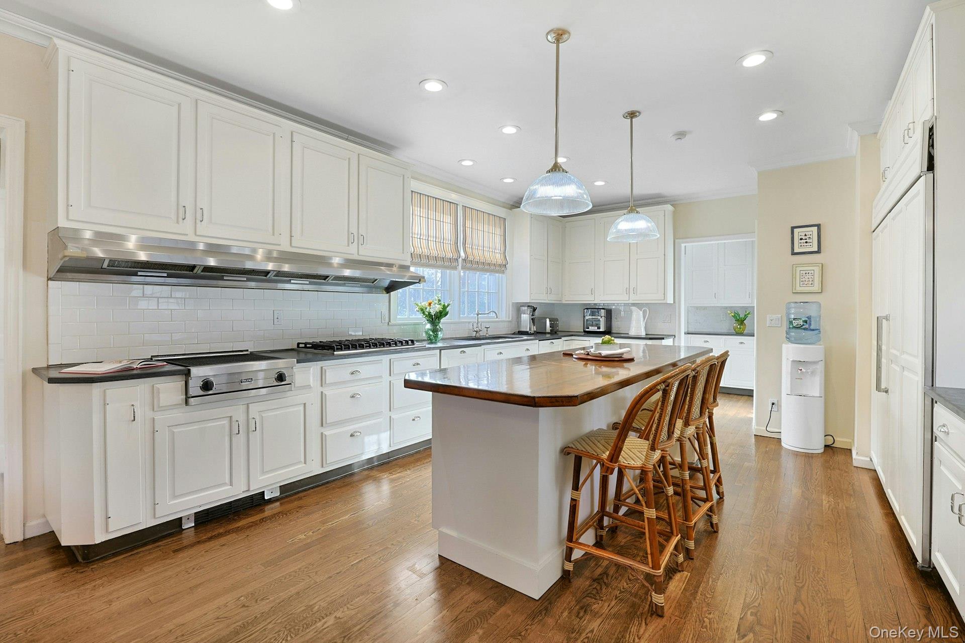 34 Park Road Scarsdale, NY 10583 - Photo 14 of 49 a kitchen with stainless steel appliances granite countertop a sink a stove a refrigerator and island with wooden floor