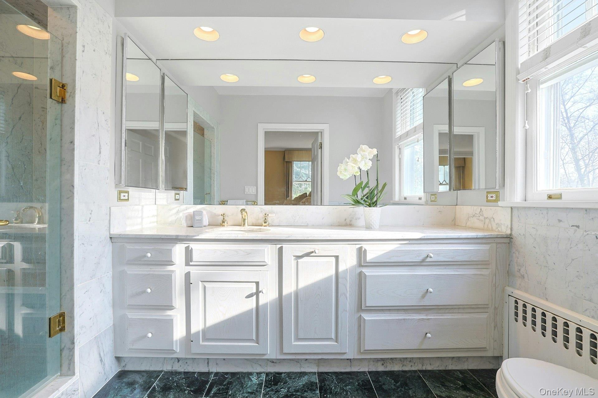 34 Park Road Scarsdale, NY 10583 - Photo 19 of 49 a bathroom with a sink vanity and mirror