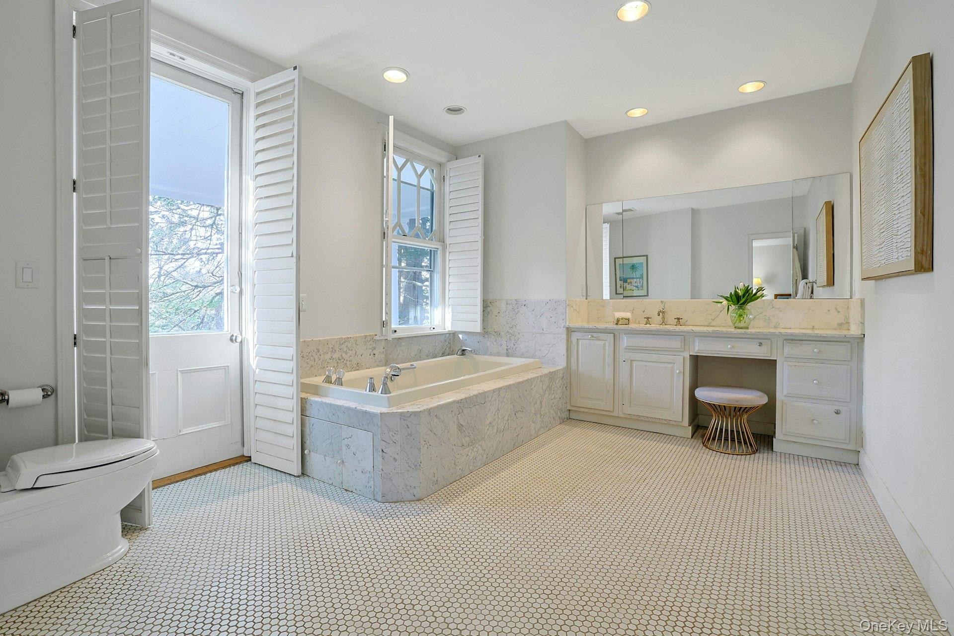 34 Park Road Scarsdale, NY 10583 - Photo 20 of 49 a spacious bathroom with a tub double sink and glass door