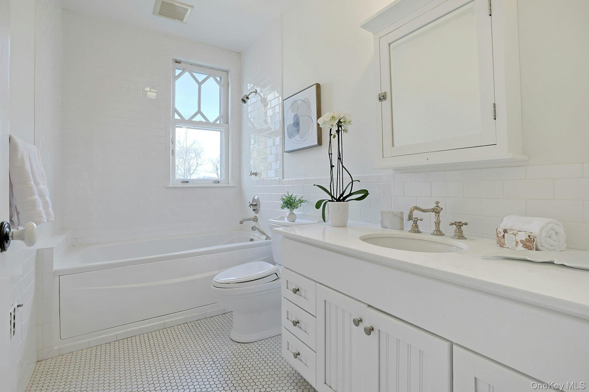 34 Park Road Scarsdale, NY 10583 - Photo 25 of 49 a bathroom with a sink toilet vanity and tub