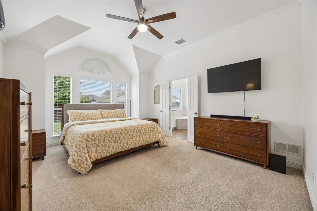 9217 Inverness Drive Rowlett, TX 75089 - Photo 18 of 40 Private Owner’s Suite Retreat — Vaulted ceilings, tall windows, and generous wall space create a spacious owner’s suite with a calm, tucked-away feel.
