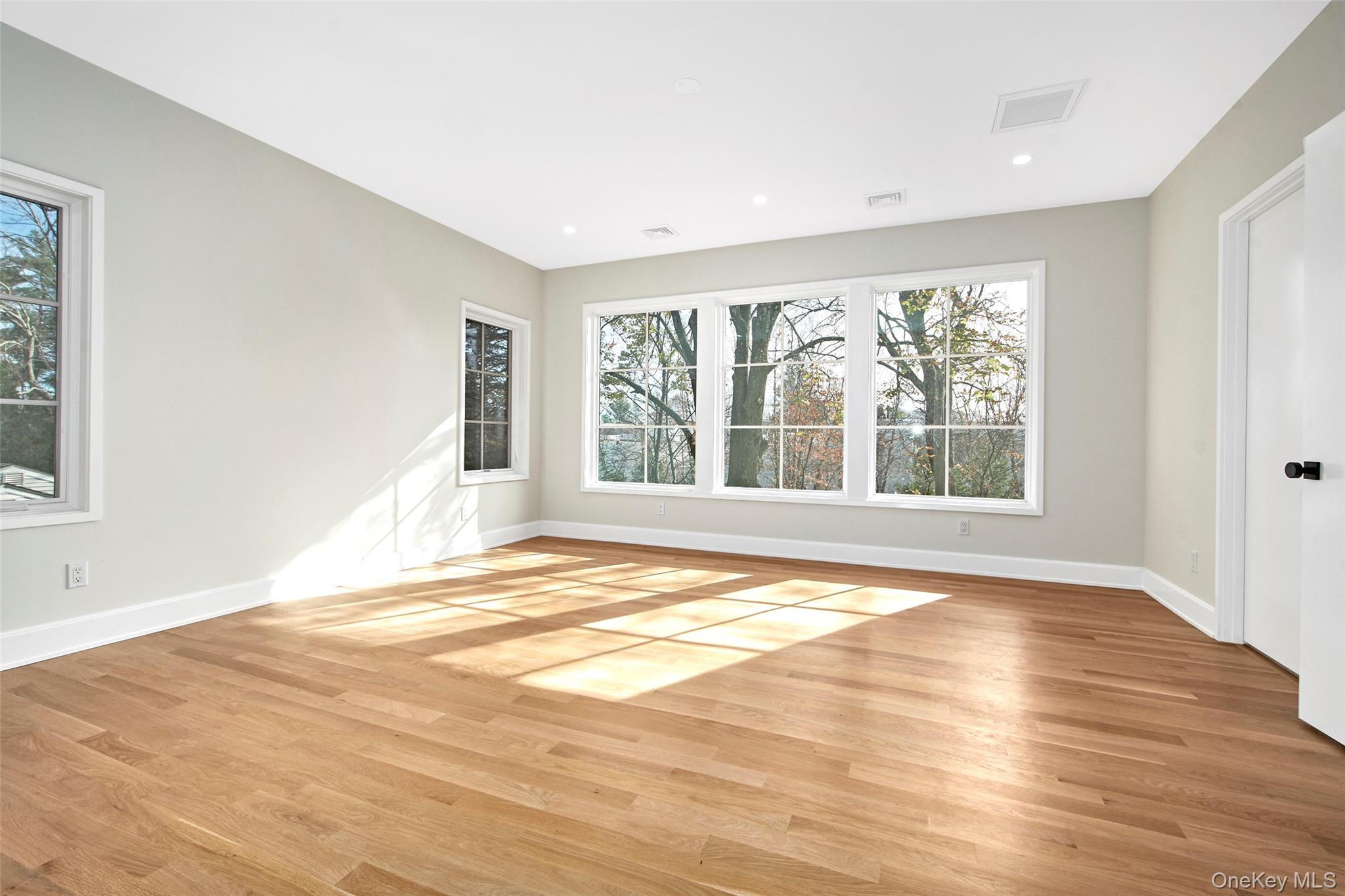 2 Myrtledale Road Scarsdale, NY 10583 - Photo 12 of 33 a view of an empty room with wooden floor and a window