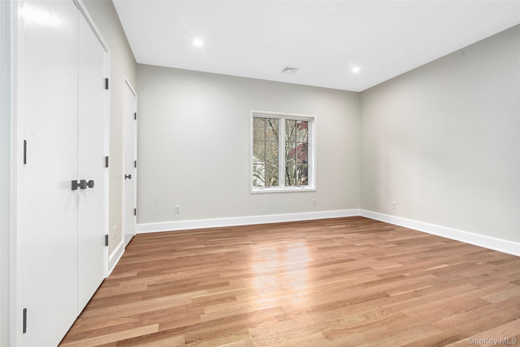 2 Myrtledale Road Scarsdale, NY 10583 - Photo 18 of 33 a view of an empty room with wooden floor and a window