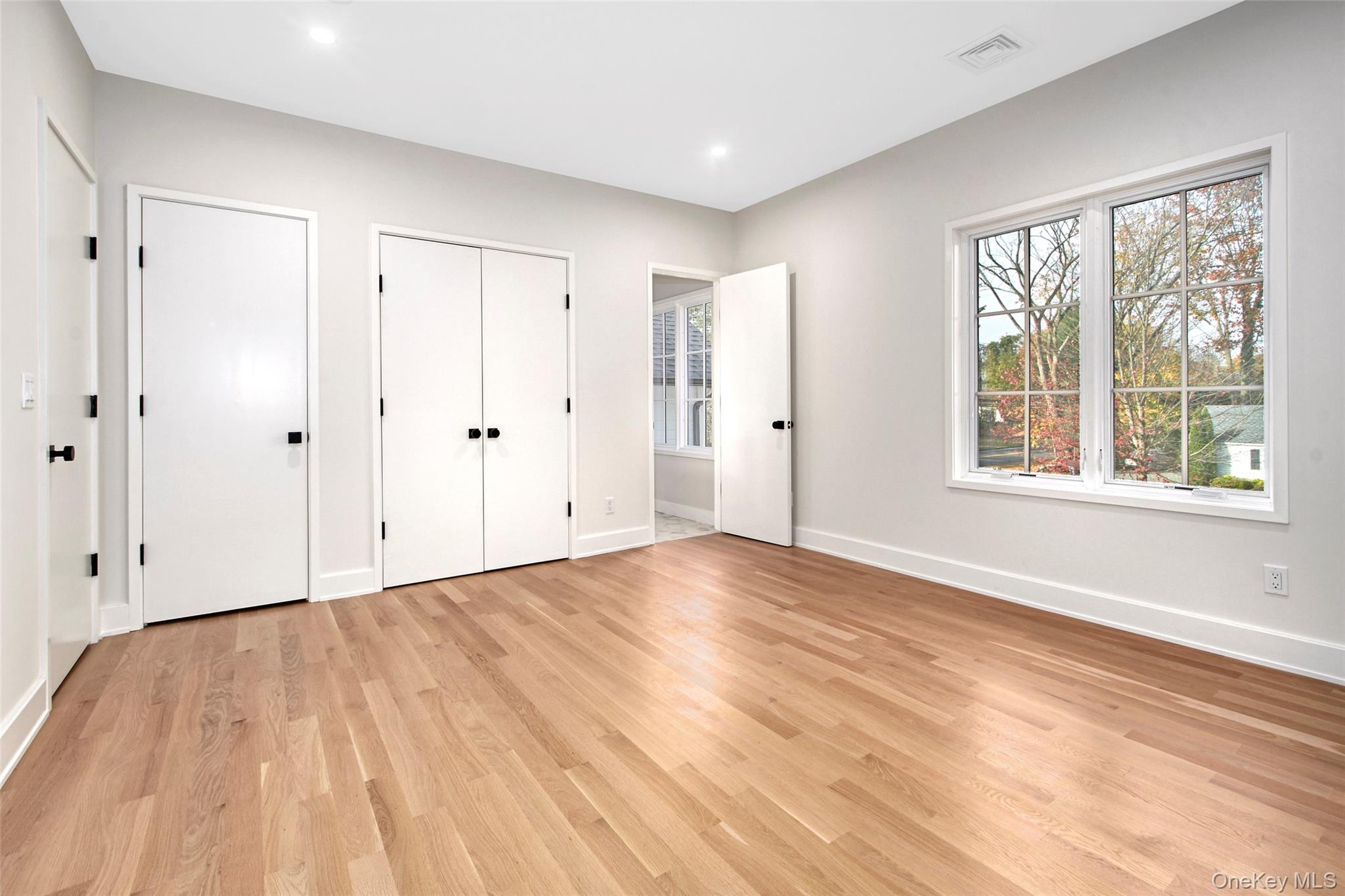 2 Myrtledale Road Scarsdale, NY 10583 - Photo 19 of 33 a view of an empty room with wooden floor and a window