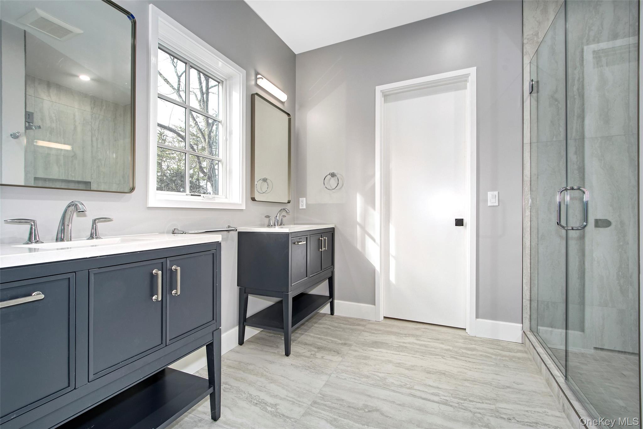 2 Myrtledale Road Scarsdale, NY 10583 - Photo 22 of 33 a spacious bathroom with a double vanity sink a mirror and a bathtub