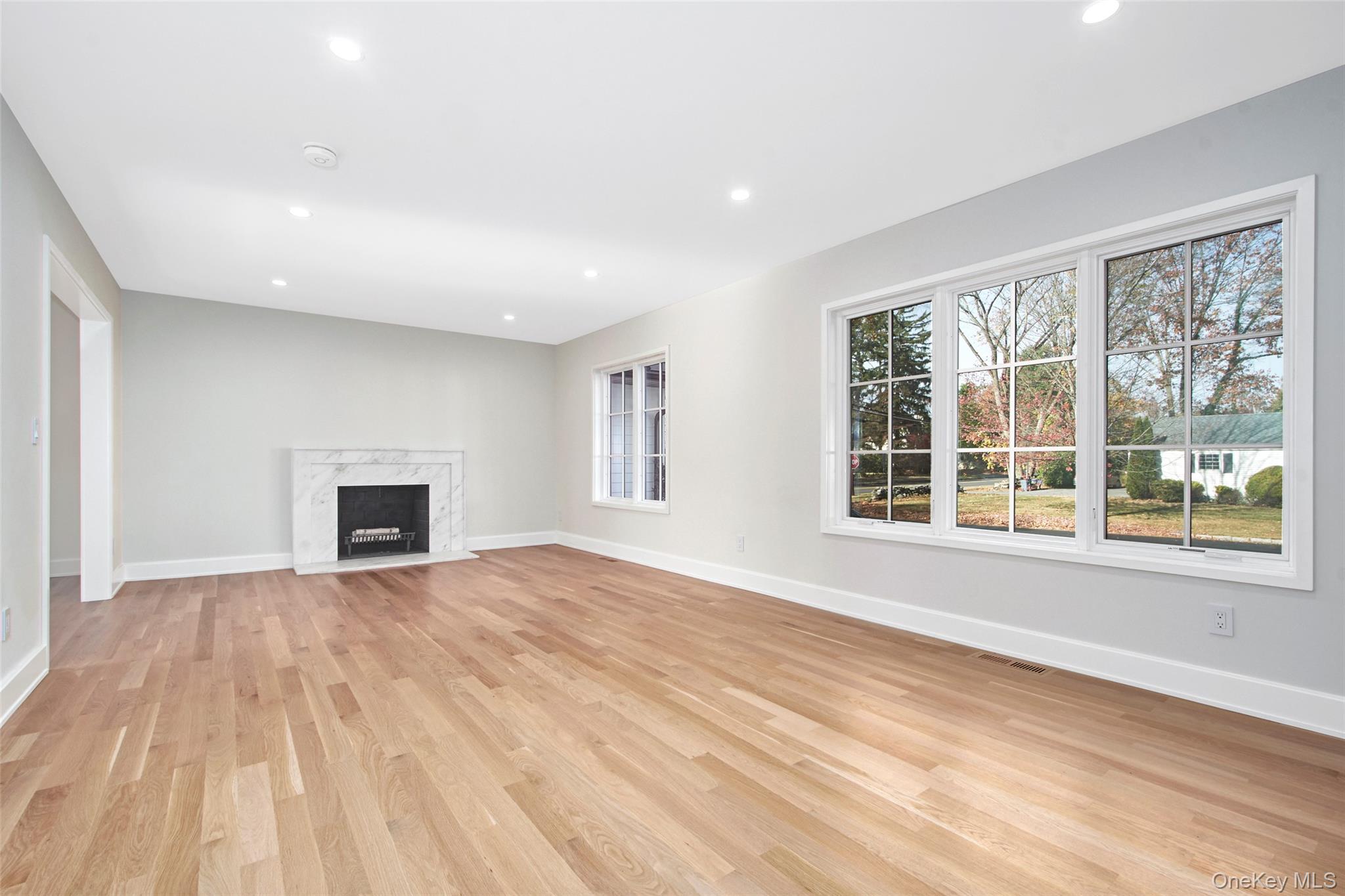 2 Myrtledale Road Scarsdale, NY 10583 - Photo 7 of 33 a view of empty room with wooden floor and fireplace