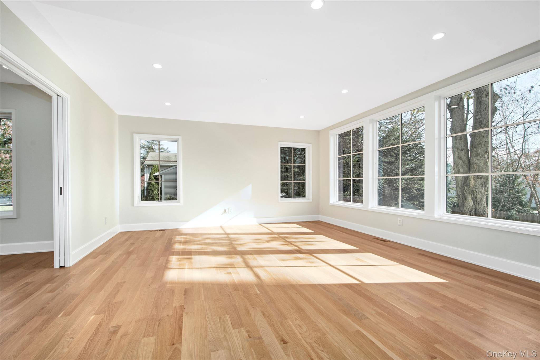 2 Myrtledale Road Scarsdale, NY 10583 - Photo 8 of 33 a view of an empty room with wooden floor and a window
