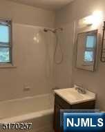 743 Newcomb Road Ridgewood, NJ 07450 - Photo 14 of 19 a bathroom with a granite countertop sink a toilet and shower