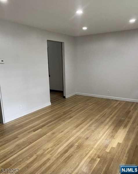 743 Newcomb Road Ridgewood, NJ 07450 - Photo 6 of 19 an empty room with wooden floor and natural light