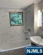 743 Newcomb Road Ridgewood, NJ 07450 - Photo 8 of 19 a bathroom with a bathtub and a sink