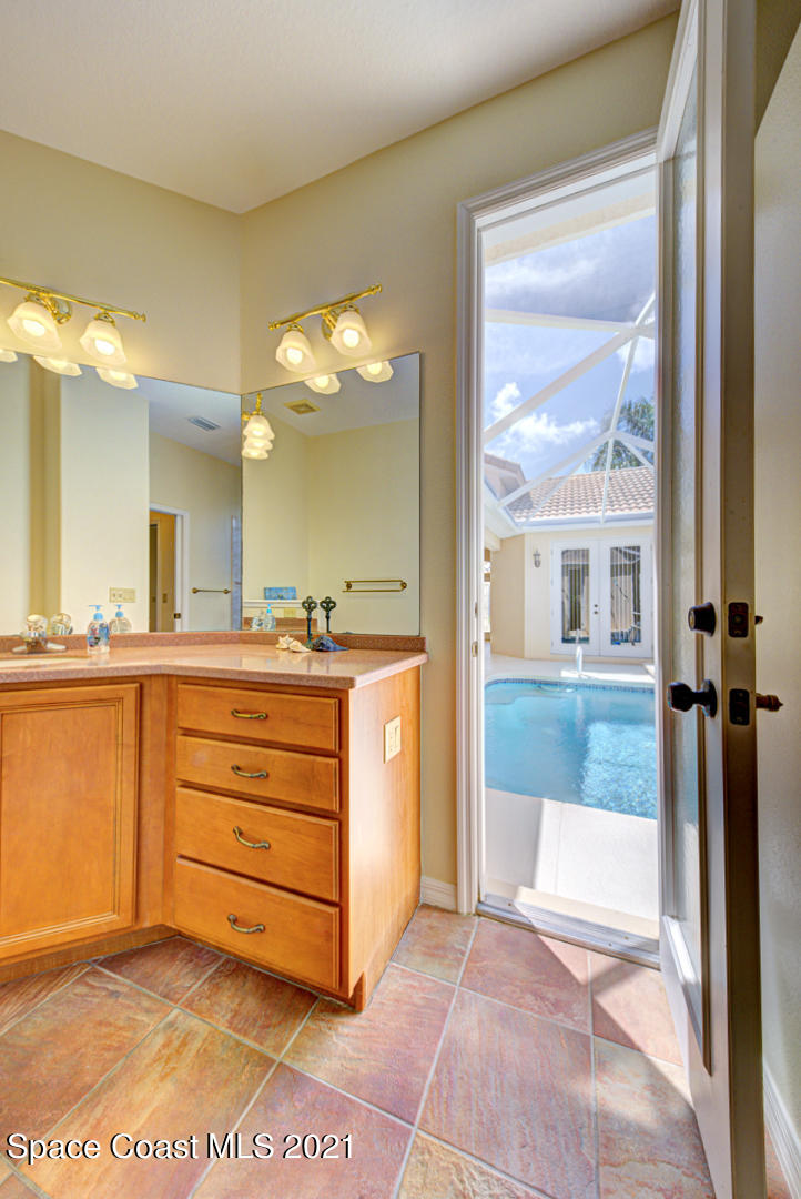 8206 Simpkins Way Melbourne, FL 32940 - Photo 47 of 66 master bathroom with cabana door (1) - C