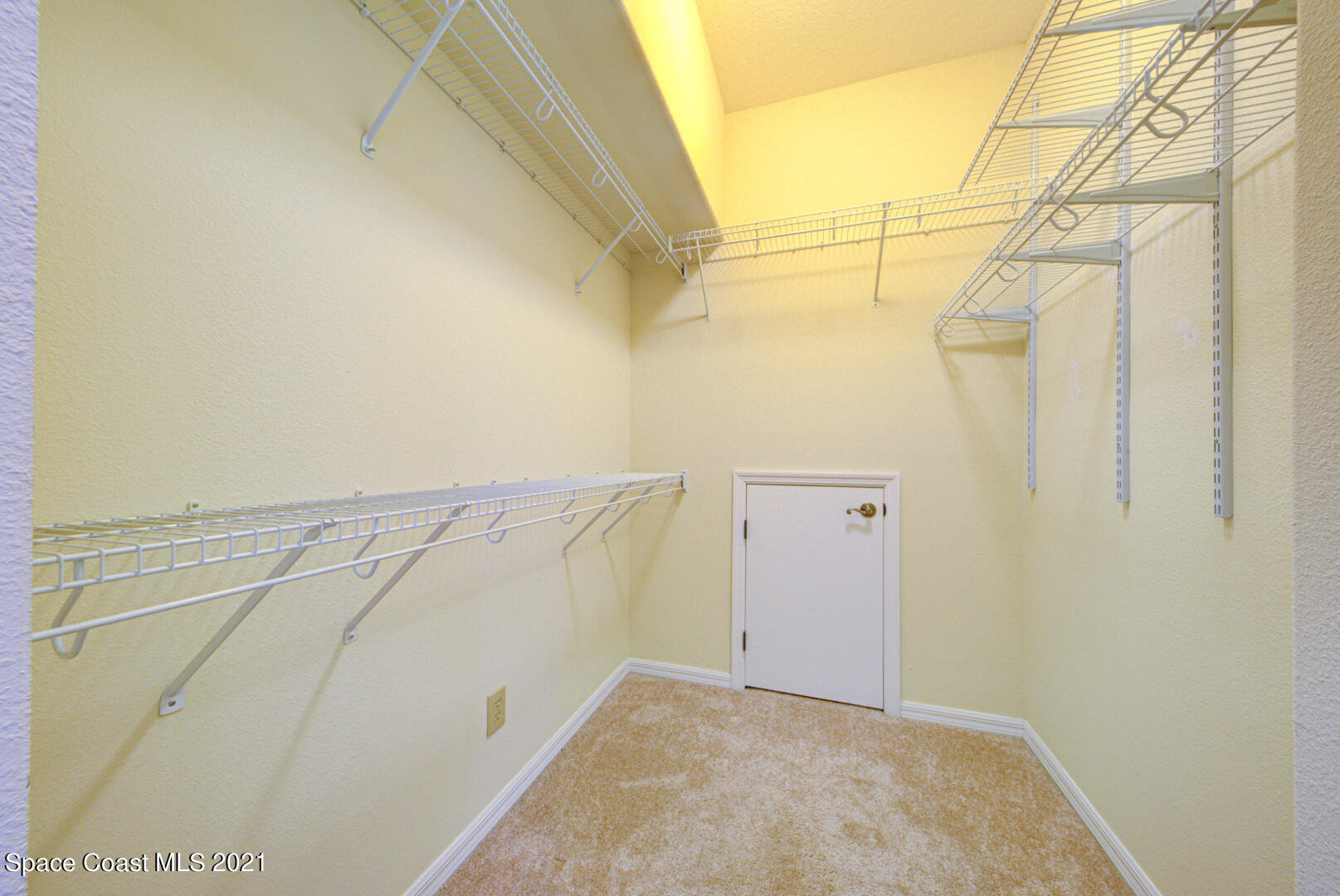 8206 Simpkins Way Melbourne, FL 32940 - Photo 51 of 66 master walk-in closet #1 with hidden sto