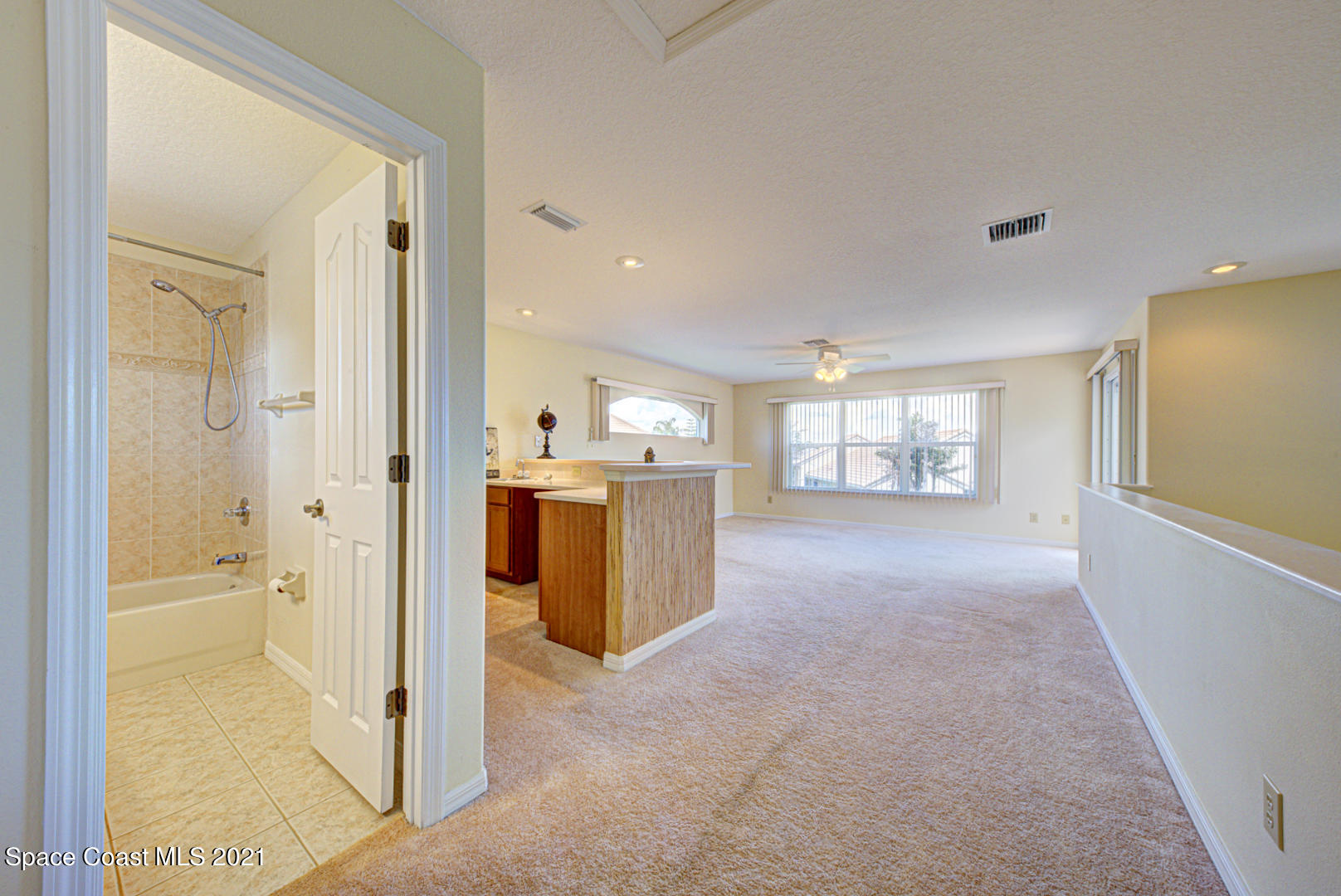 8206 Simpkins Way Melbourne, FL 32940 - Photo 61 of 66 second floor loft with bathroom (1) - Co