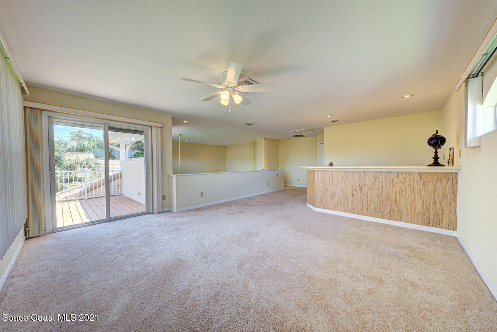8206 Simpkins Way Melbourne, FL 32940 - Photo 63 of 66 second floor loft with slider to balcony