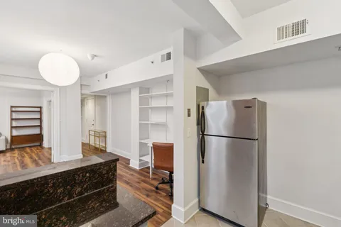 a kitchen with a refrigerator and a stove