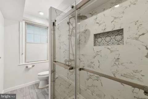 a bathroom with a shower toilet and sink