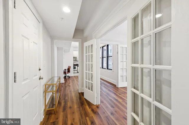 a view of a hallway with wooden floor and staircase