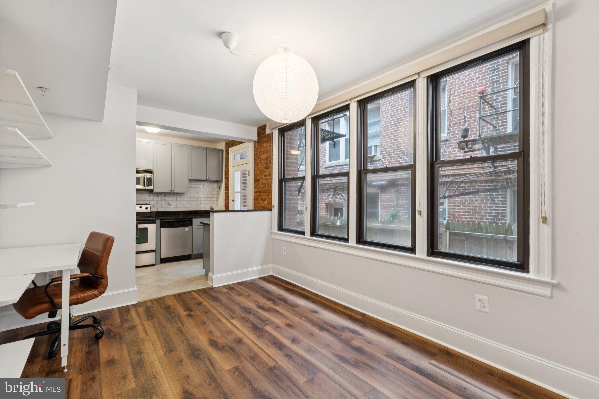 1858 California Street Northwest, Unit 5 Washington, DC 20009 - Photo 8 of 23 a view of a kitchen with wooden floor and a window