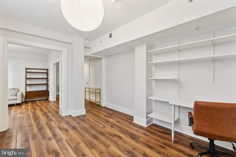 a view of a room with wooden floor and closet