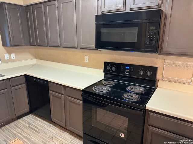 a kitchen with a stove and microwave