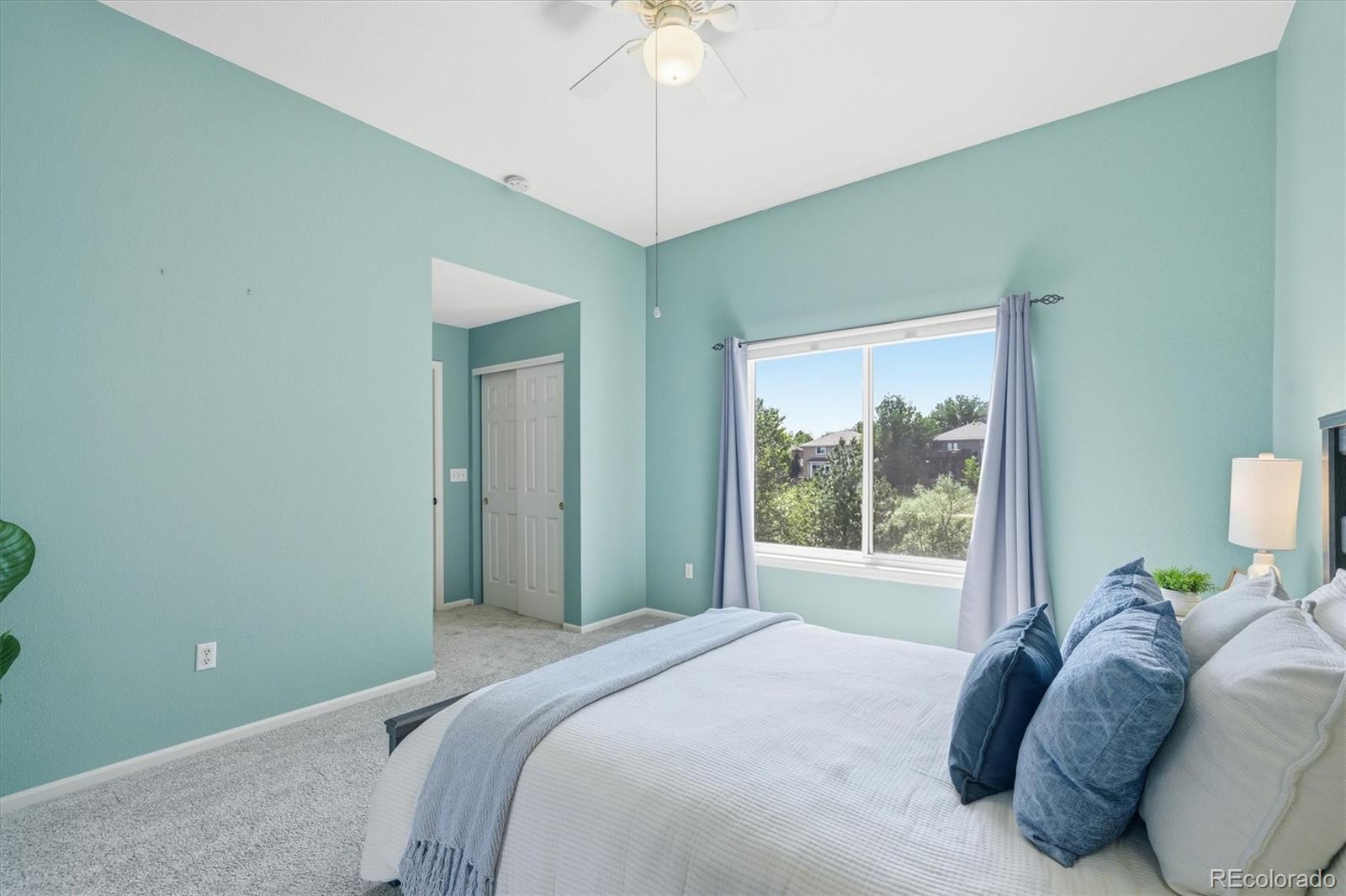 9629 Burberry Way Highlands Ranch, CO 80129 - Photo 24 of 50 a bedroom with a bed and a chandelier