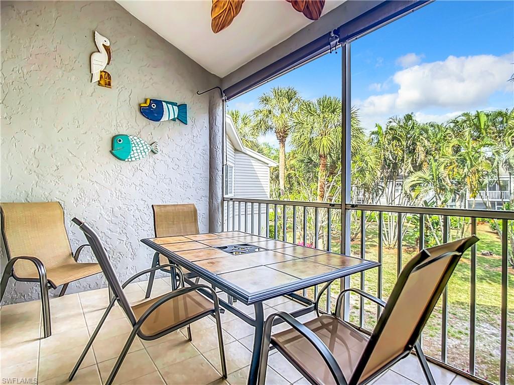 2860 Citrus Lake Drive, Unit R202 Naples, FL 34109 - Photo 45 of 50 a view of a balcony with table and chairs
