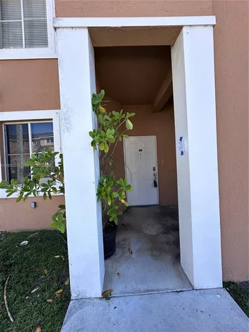 a vase with flowers sitting on a floor