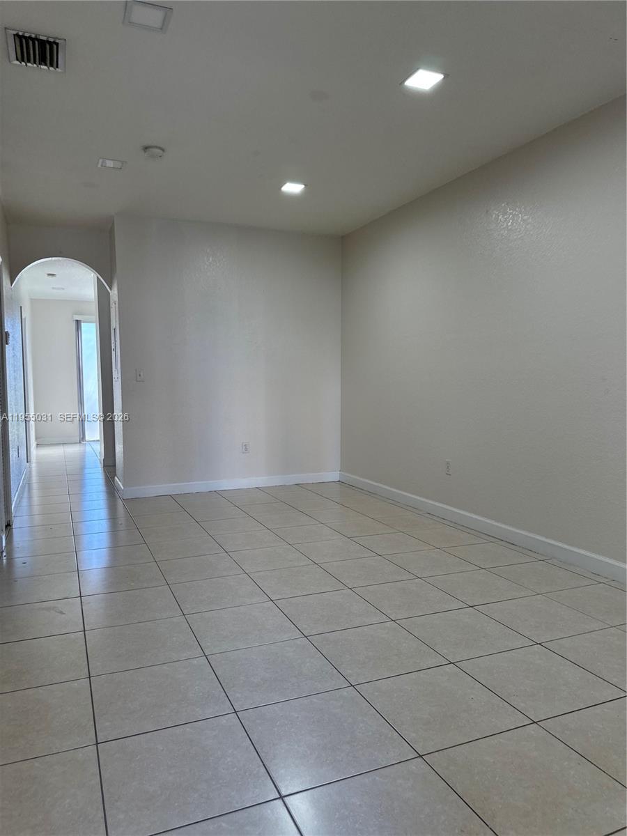 7090 Northwest 177th Street, Unit 1009 Hialeah, FL 33015 - Photo 2 of 9 a view of a livingroom with wooden floor