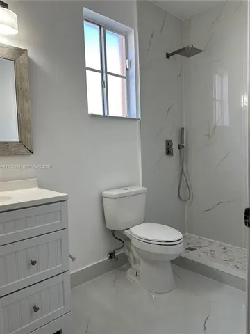 a bathroom with a toilet sink and window