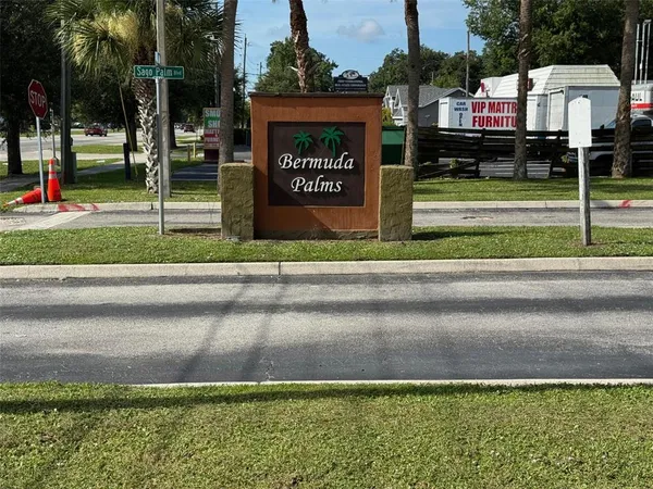a view of a street with a building and a street sign