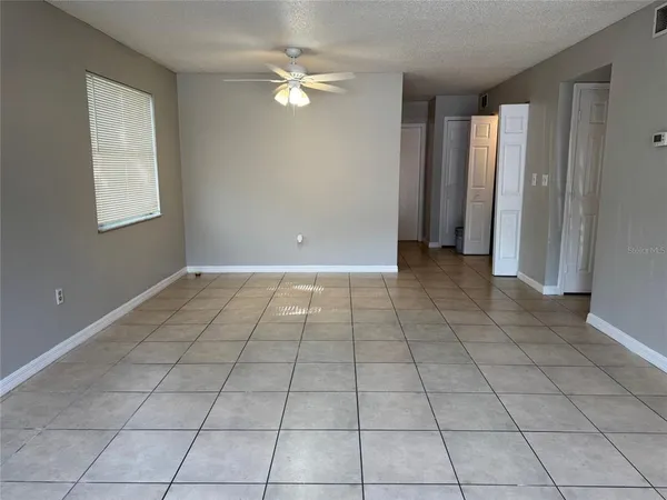 an empty room with windows and closet