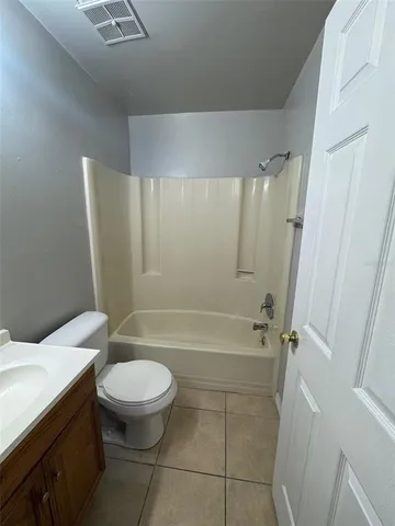 a bathroom with a toilet a sink and bathtub