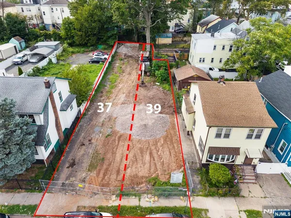 an aerial view of a house with a yard basket ball court and outdoor seating