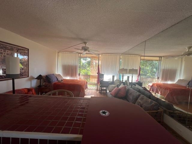 120 Hui Rd F, Unit I16 Lahaina, HI 96761 - Photo 16 of 28 a living room with furniture a large window and a chandelier