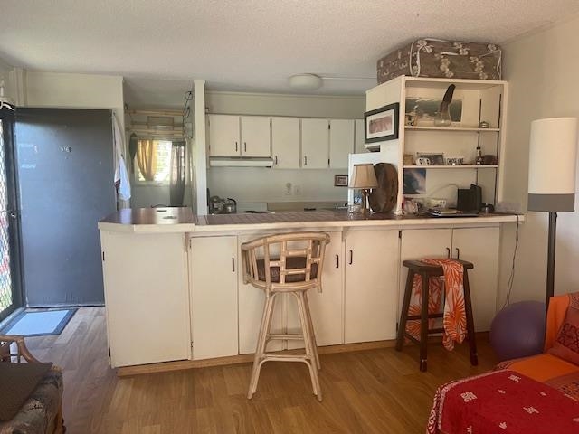 120 Hui Rd F, Unit I16 Lahaina, HI 96761 - Photo 9 of 28 a dining room with furniture and wooden floor