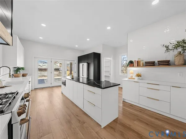 a kitchen with a sink a counter and chairs