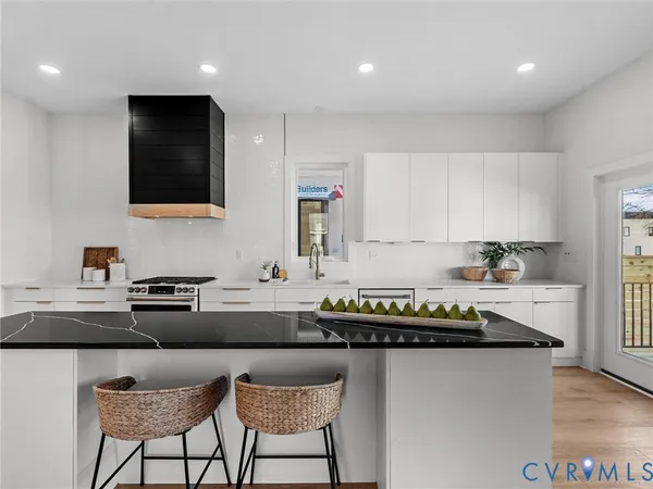 a kitchen with stainless steel appliances a sink a stove a refrigerator and a refrigerator