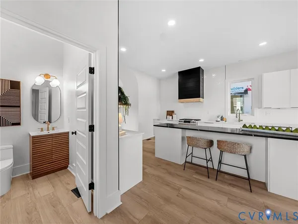 a large kitchen with stainless steel appliances kitchen island granite countertop a sink and cabinets