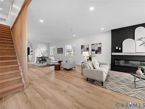 a living room with furniture potted plant and a fireplace