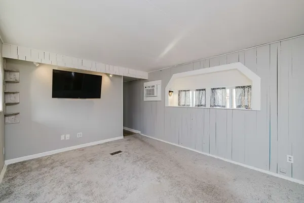 a view of an empty room with a flat screen tv